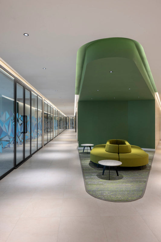 Modern hospital corridor at Almoosa Rehabilitation Hospital featuring a green ceiling design, glass office partitions, and a vibrant green circular seating area – ممر حديث في مستشفى الموسى للتأهيل بتصميم سقف أخضر، وفواصل زجاجية، ومنطقة جلوس دائرية بلون أخضر زاهي 5