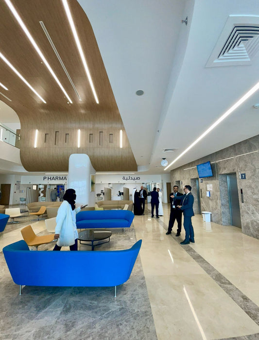 Modern interior of a hospital with blue sofas designed for healthcare use by Atelier 21 KSA, top interior designer in Saudi Arabia – تصميم داخلي عصري لمستشفى يحتوي على كنبات زرقاء مخصصة للرعاية الصحية من تصميم مفن الرسام، أفضل مصمم داخلي في السعودية 5