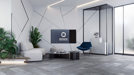 Modern lounge at Mawan Real Estate Offices in Riyadh, featuring contemporary seating, geometric wall design, indoor plants, and sleek coffee tables for a welcoming atmosphere. Executed by a Top Interior Designer in Saudi Arabia and furnished by a Top Office Furniture Supplier in Riyadh, the space blends elegance and comfort. صالة انتظار عصرية في شركة موان العقارية بالرياض من عمل أفضل مصمم داخلي في السعودية وتشطيب من أفضل شركة تنفيذ تشطيبات داخلية في الرياض. 3