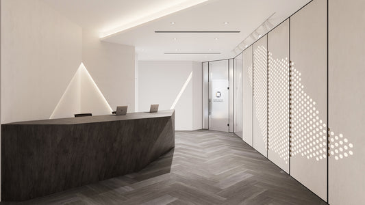 Elegant reception area at Mawan Real Estate Offices in Riyadh, featuring a sleek dark reception desk, geometric wall lighting, and modern wall panel with Saudi Arabia map design. Executed by a Top Interior Designer in Saudi Arabia and delivered by a Top Interior Fit-out Company in Riyadh, the space combines identity with sophistication. مكتب استقبال أنيق في شركة موان العقارية بالرياض من عمل أفضل مصمم داخلي في السعودية وتشطيب من أفضل شركة تنفيذ تشطيبات داخلية في الرياض. 1