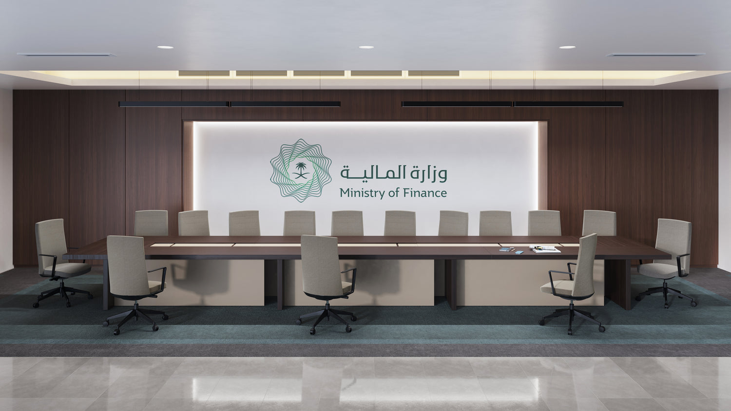 Modern conference room at the Ministry of Finance with a long wooden meeting table, executive chairs, and the Ministry of Finance logo on the wall – قاعة اجتماعات حديثة في وزارة المالية تحتوي على طاولة خشبية طويلة وكراسي تنفيذية مع شعار وزارة المالية على الجدار