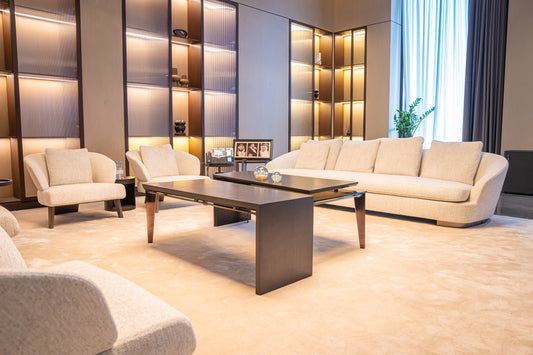 Modern office seating area with cream sofas, armchairs, wooden coffee tables, and built-in shelving by Atelier 21 KSA, top interior designer in Saudi Arabia – منطقة جلوس مكتبية عصرية تحتوي على كنبات كريمية، كراسي مفردة، طاولات قهوة خشبية، وأرفف مدمجة من تصميم مفن الرسام، أفضل مصمم داخلي في السعودية 3