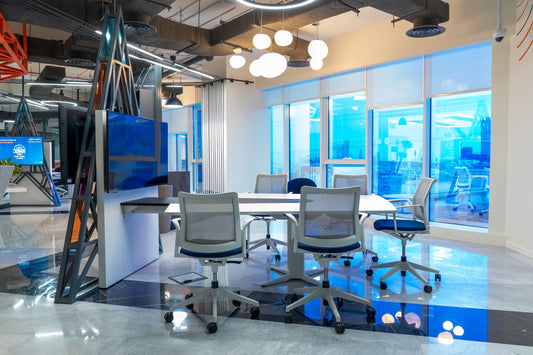 Modern collaborative workspace with sleek white meeting table, ergonomic mesh chairs, ambient ceiling lights, and large windows offering natural light – located in TAWAL HQ, Riyadh – designed and fitted by Atelier 21 KSA, top interior fit-out firm in Saudi Arabia.
مساحة عمل عصرية تضم طاولة اجتماعات بيضاء وكراسي مريحة بإطار شبكي، مع إضاءة معلقة ونوافذ كبيرة للضوء الطبيعي – ضمن مقر TAWAL في الرياض – من تنفيذ مفن الرسام، أفضل شركة تصميم داخلي في السعودية. 8