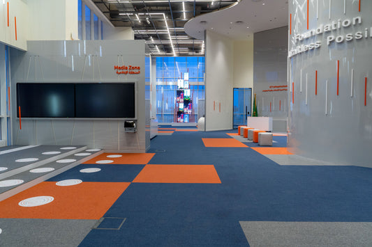 A futuristic media and ICT infrastructure zone with bold orange and blue flooring, integrated LED lighting, and interactive screens – part of TAWAL's smart office in Riyadh – designed by Atelier 21 KSA, leading interior fit-out company in Saudi Arabia and Riyadh.
منطقة إعلامية وتقنية بتصميم عصري، تجمع بين الأرضيات الزرقاء والبرتقالية والإضاءة التفاعلية والشاشات الذكية – ضمن مكاتب TAWAL الذكية في الرياض – من تنفيذ مفن الرسام، أفضل شركة تصميم داخلي في السعودية والرياض. 7