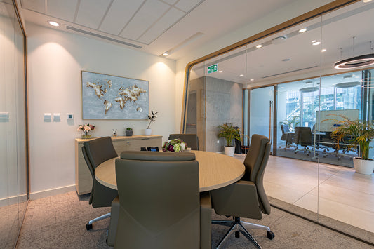 Stylish small meeting room at Azm Saudi Project, featuring a round wooden table, leather chairs, glass partitions, and decorative plants, creating a modern corporate design. Executed by a Top Interior Designer in Riyadh and furnished by a Top Office Furniture Supplier in Saudi Arabia, the room enhances collaboration. غرفة اجتماعات صغيرة أنيقة في مشروع عزم السعودية من عمل أفضل مصمم داخلي في السعودية وتشطيب من أفضل شركة تنفيذ تشطيبات داخلية في الرياض. 12