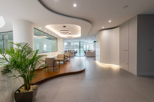 Modern office reception and hallway with elegant seating, indoor plants, and contemporary ceiling lights by Atelier 21 KSA – مفن الرسام, top office furniture supplier, top interior designer, Best interior fit-out in Riyadh, Saudi Arabia – استقبال وممر مكتبي حديث مع مقاعد أنيقة، نباتات داخلية، وإضاءة عصرية من مفن الرسام، أفضل مورد أثاث مكتبي وأفضل مصمم داخلي وافضل شركة تشطيبات داخلية في الرياض، السعودية 12