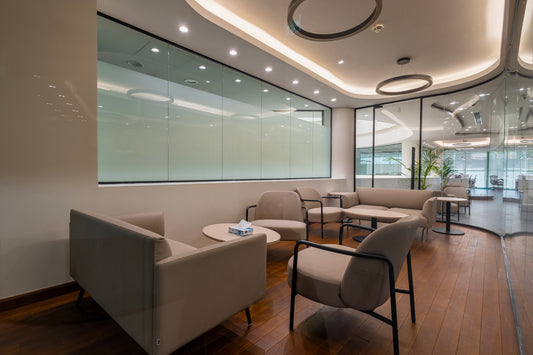 Modern office lounge area with beige sofas, armchairs, and coffee tables on wooden flooring, designed by Atelier 21 KSA – مفن الرسام. Top office furniture supplier, top interior designer, top furniture supplier in Riyadh, top designer in Saudi Arabia, Best interior fit-out in Riyadh – منطقة استراحة مكتبية حديثة بأرائك وكراسي بلون بيج وطاولات قهوة على أرضية خشبية من مفن الرسام، أفضل مورد أثاث مكتبي وأفضل مصمم داخلي وافضل شركة تشطيبات داخلية في الرياض، السعودية 13