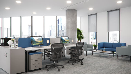 Modern open office space with ergonomic chairs, workstations, and blue sofas, designed by Atelier 21 KSA – مفن الرسام, top office furniture supplier and top interior designer in Riyadh, Saudi Arabia – مساحة مكتبية مفتوحة حديثة تحتوي على كراسي مريحة، محطات عمل، وأرائك زرقاء من مفن الرسام، أفضل مورد أثاث مكتبي وأفضل مصمم داخلي في الرياض، السعودية 4