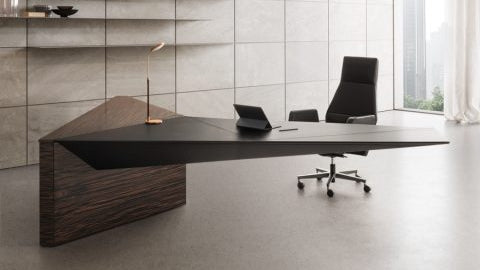 Modern office with a large desk, chair, and shelves in a well-lit room.